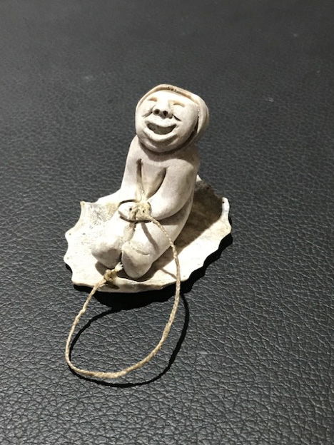 Inuit artist Silas Kayakjuak (Qayaquaq) captures the joy of a child sledding in this sculpture